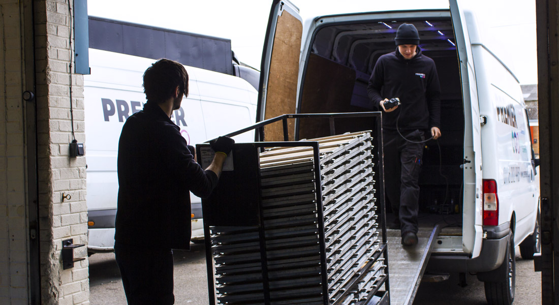 Loading the equipment in the van, ready for delivery.